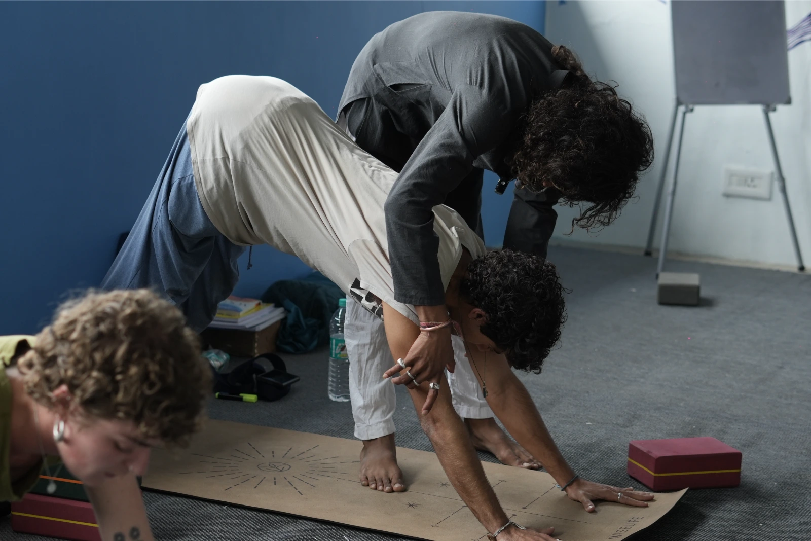 Teacher guiding a student through a seated twist